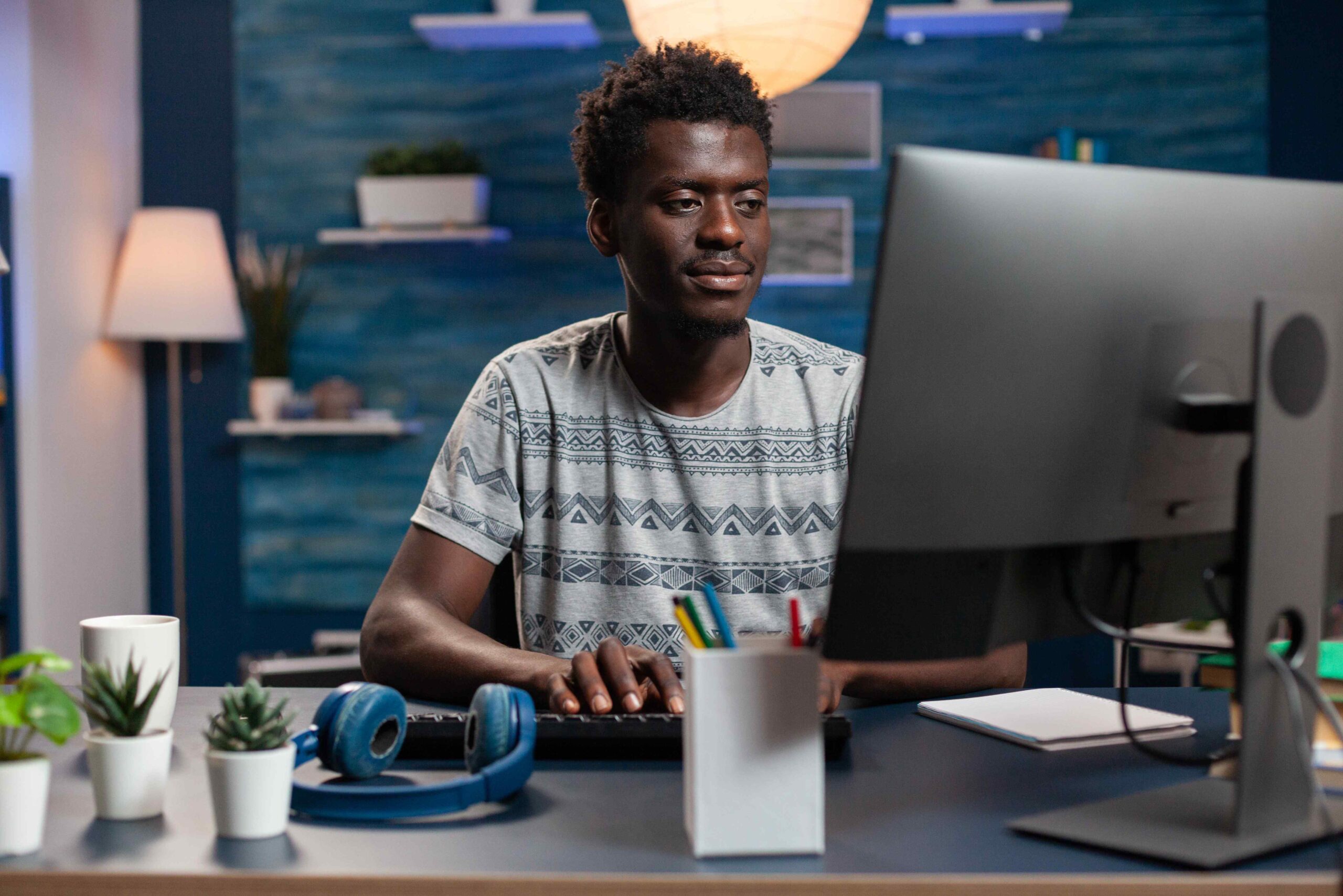 Portrait of african american employee using computer while working remote from home